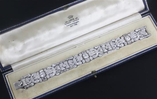 An attractive 1930s/1940s Art Deco white gold and diamond encrusted bracelet in Jays of London fitted box, 7in.